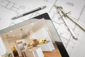 Here you can see a printed custom home floor plan with an iPad showing the completed home sitting on top. Your custom home builder will help you select & customize your home.